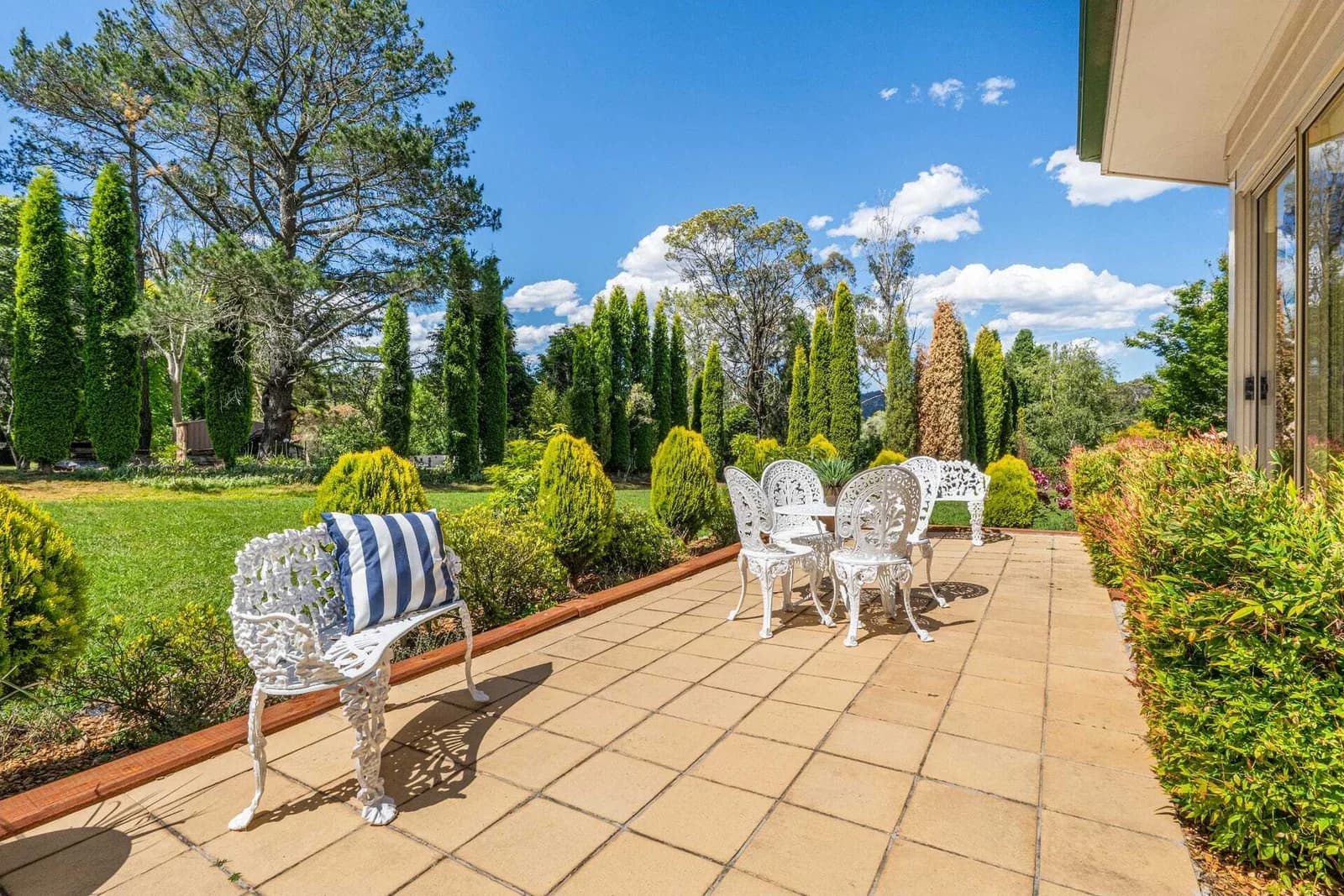 Current paved garden terrace with lawn and established planting